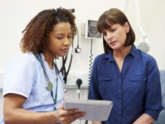 Nurse showing female patient her abnormal pap smear test results