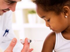 Doctor injects vaccine into a child's arm