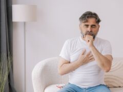 A man with COPD coughing at home