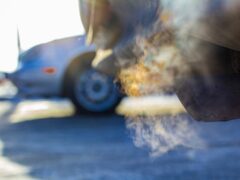 An idling car polluting the air.